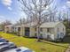 Condo building exterior with trees and parking at 1433 Pine Glen Pl # D1, Tarpon Springs, FL 34688