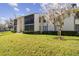 Condo building exterior with landscaping at 1433 Pine Glen Pl # D1, Tarpon Springs, FL 34688