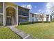 Two-story condo building with screened balconies and walkway at 1433 Pine Glen Pl # D1, Tarpon Springs, FL 34688