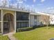 Two-story condo building with screened balconies and manicured lawn at 1433 Pine Glen Pl # D1, Tarpon Springs, FL 34688