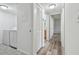 Clean hallway with washer, dryer, and bathroom access at 1433 Pine Glen Pl # D1, Tarpon Springs, FL 34688
