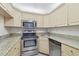 Kitchen with stainless steel appliances and granite countertops at 1433 Pine Glen Pl # D1, Tarpon Springs, FL 34688