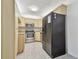 Galley kitchen with stainless steel appliances and granite counters at 1433 Pine Glen Pl # D1, Tarpon Springs, FL 34688