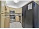 Galley kitchen with stainless steel appliances and granite counters at 1433 Pine Glen Pl # D1, Tarpon Springs, FL 34688