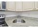 Kitchen features granite countertops and stainless steel sink at 1433 Pine Glen Pl # D1, Tarpon Springs, FL 34688