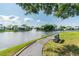 Peaceful lakeside walkway with bench for relaxation at 1433 Pine Glen Pl # D1, Tarpon Springs, FL 34688