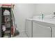 White washer and dryer in a tidy laundry room at 1433 Pine Glen Pl # D1, Tarpon Springs, FL 34688