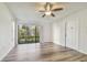 Living room with sliding glass doors and a ceiling fan at 1433 Pine Glen Pl # D1, Tarpon Springs, FL 34688