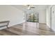 Living room with sliding glass doors and laminate flooring at 1433 Pine Glen Pl # D1, Tarpon Springs, FL 34688
