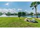 Relaxing picnic area by the lake with a table and grill at 1433 Pine Glen Pl # D1, Tarpon Springs, FL 34688