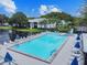 Inviting community pool with lounge chairs and umbrellas at 1433 Pine Glen Pl # D1, Tarpon Springs, FL 34688