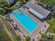 Community pool with surrounding lounge chairs and spa at 1433 Pine Glen Pl # D1, Tarpon Springs, FL 34688