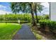 Paved walkway meanders beside a pond, offering scenic views at 1433 Pine Glen Pl # D1, Tarpon Springs, FL 34688