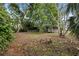 Large backyard with mature trees and a shed at 150 Almedo Ne Way, St Petersburg, FL 33704