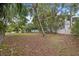 Spacious backyard with mature trees and landscaping at 150 Almedo Ne Way, St Petersburg, FL 33704