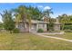 Cute ranch home with a large yard and mature landscaping at 150 Almedo Ne Way, St Petersburg, FL 33704