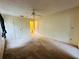 Carpeted bedroom with ceiling fan and access to bathroom at 1568 Nantucket Ct # 1302, Palm Harbor, FL 34683