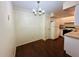 Simple dining room with laminate flooring and chandelier at 1568 Nantucket Ct # 1302, Palm Harbor, FL 34683