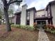 Exterior view of condo building, showing landscaping and building features at 1568 Nantucket Ct # 1302, Palm Harbor, FL 34683