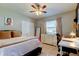Bedroom with a ceiling fan, work area, and bed at 16115 Country Crossing Dr, Tampa, FL 33624