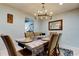Elegant dining room with chandelier, table, and seating for six at 16115 Country Crossing Dr, Tampa, FL 33624