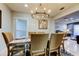 Bright dining room features a rustic table, chandelier, and seating for six at 16115 Country Crossing Dr, Tampa, FL 33624