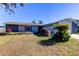 Gray house with landscaped lawn and driveway at 16115 Country Crossing Dr, Tampa, FL 33624