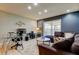 Open living area with sectional sofa, decorative accents, and adjacent home office at 16115 Country Crossing Dr, Tampa, FL 33624