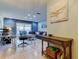 Home office features glass desk, comfortable seating, and a view of the backyard at 16115 Country Crossing Dr, Tampa, FL 33624