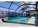 Relaxing screened-in pool with brick coping and lounge chairs at 16115 Country Crossing Dr, Tampa, FL 33624