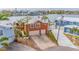 Two-story house with attached two-car garage, waterfront lot, and palm trees at 16134 4Th E St, Redington Beach, FL 33708