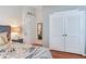 Bedroom with wood floors and louvered closet doors at 16134 4Th E St, Redington Beach, FL 33708