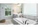 Relaxing bathroom with soaking tub, separate shower, and double vanity at 1815 Sunset Wind Loop # 118, Oldsmar, FL 34677