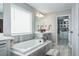 Elegant bathroom with soaking tub, walk-in shower, and double vanity at 1815 Sunset Wind Loop # 118, Oldsmar, FL 34677