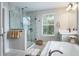 Spa-like bathroom with a soaking tub, walk-in shower, and double vanity at 1815 Sunset Wind Loop # 118, Oldsmar, FL 34677