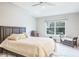 Spacious bedroom with a king-size bed and large window at 1815 Sunset Wind Loop # 118, Oldsmar, FL 34677