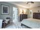 King-size bed, ensuite bath access and a dresser in this main bedroom at 1815 Sunset Wind Loop # 118, Oldsmar, FL 34677