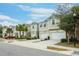 Row of townhomes with attached garages and palm trees at 1815 Sunset Wind Loop # 118, Oldsmar, FL 34677