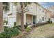 Townhome with covered porch, landscaping, and attached garage at 1815 Sunset Wind Loop # 118, Oldsmar, FL 34677