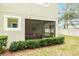 Tan building with a screened porch and hedges at 1815 Sunset Wind Loop # 118, Oldsmar, FL 34677