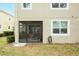 Tan building with screened patio and landscaping at 1815 Sunset Wind Loop # 118, Oldsmar, FL 34677
