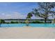 Infinity pool overlooking the water with lounge chairs at 1815 Sunset Wind Loop # 118, Oldsmar, FL 34677