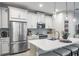 Bright kitchen with white cabinets, stainless steel appliances, and a large island at 1815 Sunset Wind Loop # 118, Oldsmar, FL 34677