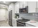Modern kitchen with stainless steel appliances and gray subway tile backsplash at 1815 Sunset Wind Loop # 118, Oldsmar, FL 34677
