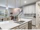 Open kitchen with large island, stainless steel appliances, and a view into dining area at 1815 Sunset Wind Loop # 118, Oldsmar, FL 34677