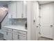 White kitchen cabinets and counter space next to staircase and pantry at 1815 Sunset Wind Loop # 118, Oldsmar, FL 34677