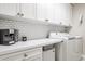 Bright laundry room with white cabinets and appliances at 1815 Sunset Wind Loop # 118, Oldsmar, FL 34677