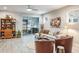 Living room featuring a sectional sofa and access to the patio at 1815 Sunset Wind Loop # 118, Oldsmar, FL 34677