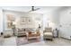 Spacious living room with a comfortable sofa, armchairs, and a ceiling fan at 1815 Sunset Wind Loop # 118, Oldsmar, FL 34677