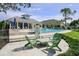 Community pool with lounge chairs and fire pit at 1815 Sunset Wind Loop # 118, Oldsmar, FL 34677